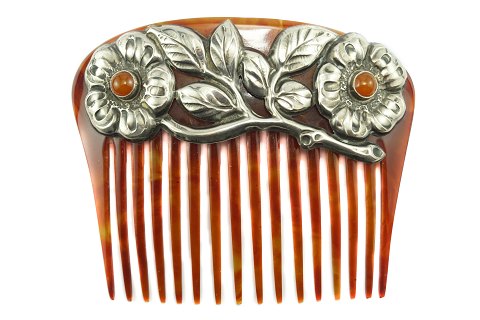 An Art Nouveau comb with silver and amber