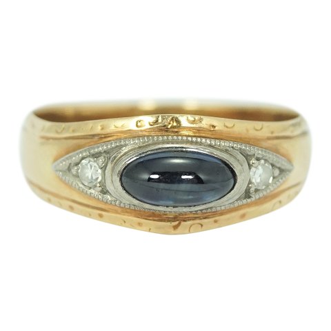 A gold ring set with a sapphire and two diamonds mounted in white gold
