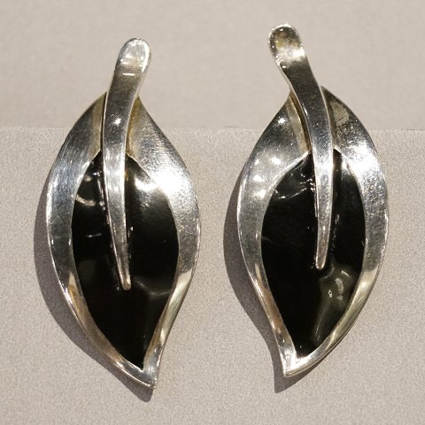 N. E. From; Earclips  of sterling silver set with black enamel