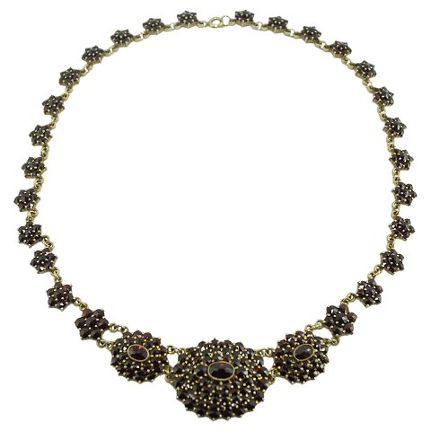 A necklace set with grenades