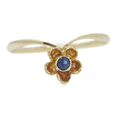 A 14k gold ring set with a sapphire