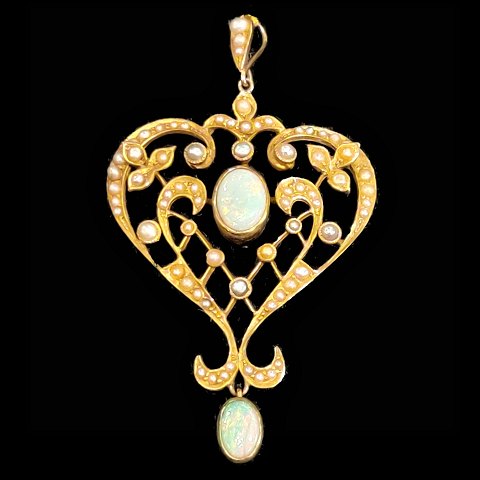 A pendant set with opals and pearls mounted in 14k gold
